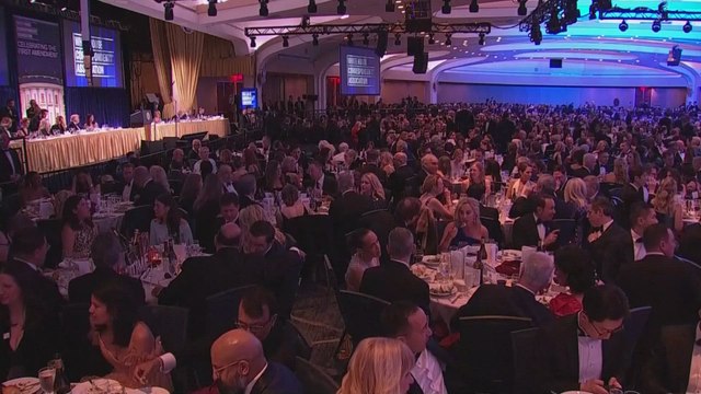 Wide shot of ballroom as loud bangs are heard and President Trump is evacuated from the White House Correspondents' Association Dinner