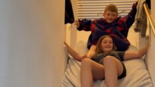 Siblings Slide Down Staircase On Mattress And Tumble Onto Floor