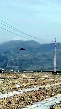 Insane footage of Iranian police officers shooting at passing low flying US airforce helicopters in Southern Iran