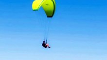 Paragliding Over Mountains on a Clear Day