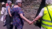 A human circle is formed around St John's Church, Wellington, as people take part in 'clipping the tower'.