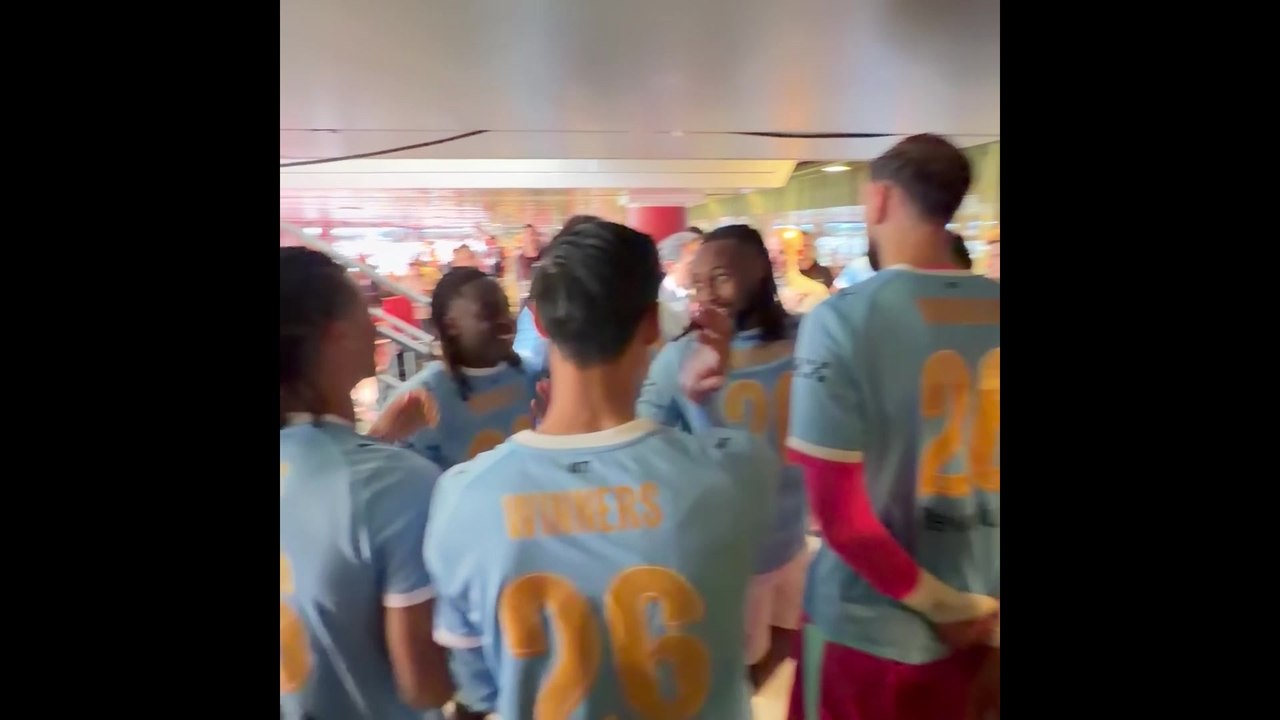 Man City players walk up the steps at Wembley to collect their winners medals and lift the trophy
