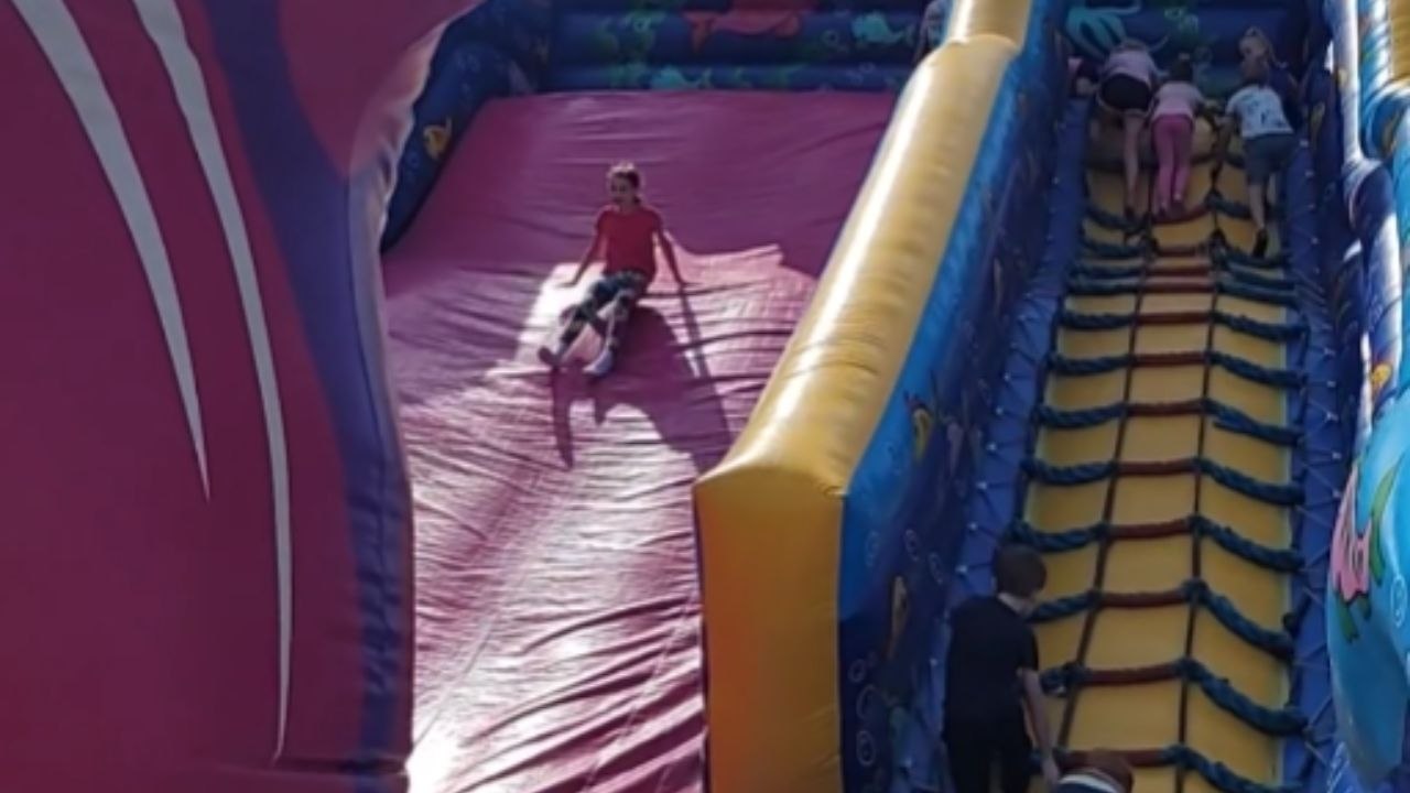 Kid Flips Off An Inflatable Slide While Coming Down