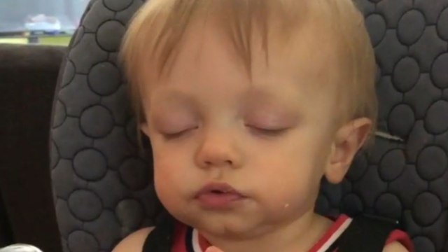 Adorable young child dozes off while snacking *charming sleep-eating*