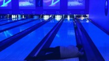 Guy tries bowling with no shoes on; hurts his knee in a nasty manner