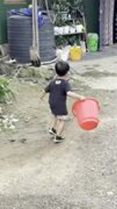 Kid Spins With Bucket on Head Before Falling