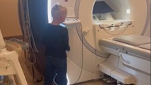Boy is shown a fun magic trick as a reward for good behavior while getting an MRI