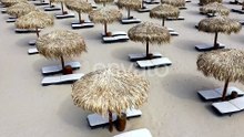 Aerial view of beach umbrellas and sunbeds on sand beach