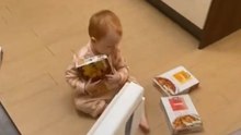 Playful dad startles his 1-year-old daughter in the kitchen