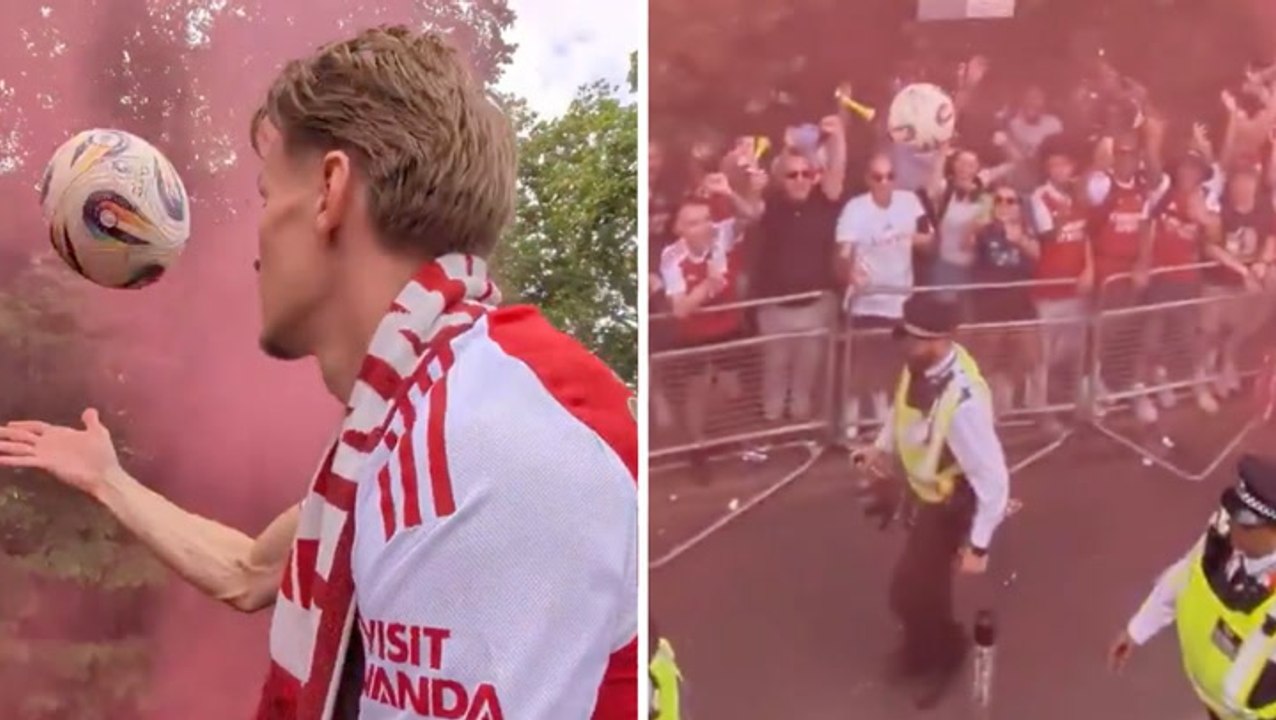 Arsenal’s Martin Ødegaard accidentally hits police officer on head with football during parade