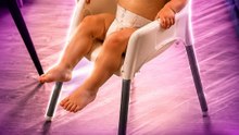 The little boy turns his baby chair into transport to reach the table