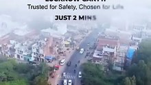 Aerial drone view of a busy road near Lucknow Cantt, highlighted as being just 2 minutes away from the property.