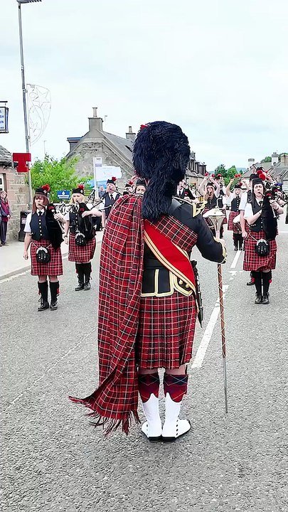 Drum Major Nick Stables and Pipe Major Kim Slater lead Dufftown _ District Pipe band morning march_ playing the Braes of Killiecrankie and Bonnie Lass o_ Fyv