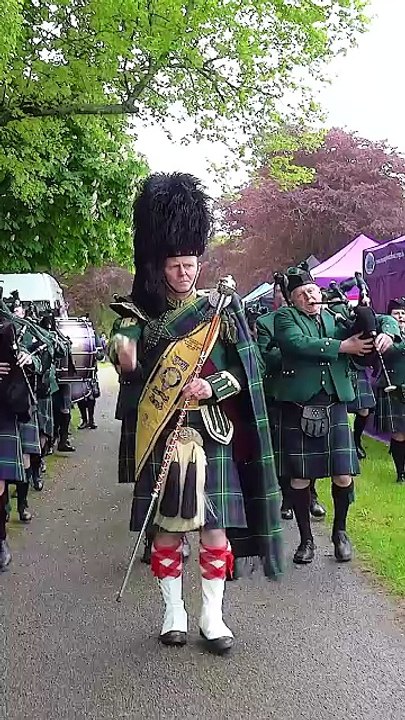 Huntly _ District Pipe Band_ led by Drum Major Derek Dean and Pipe Major Ian Stuart_ march in playing Bloody Fields of Flanders. This was the start of their