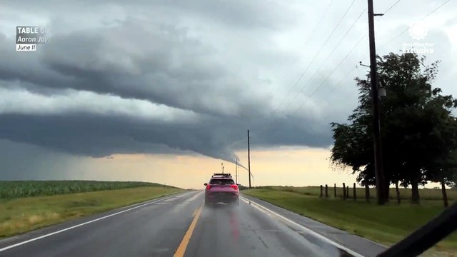 Storm chaser approaches tornado forming over western Illinois