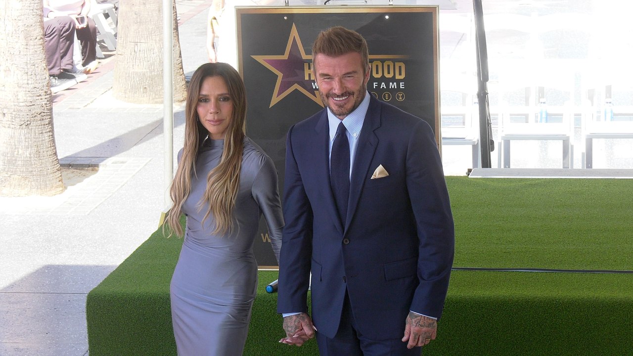 David Beckham poses with Victoria Beckham next to his star on the Hollywood Walk of Fame