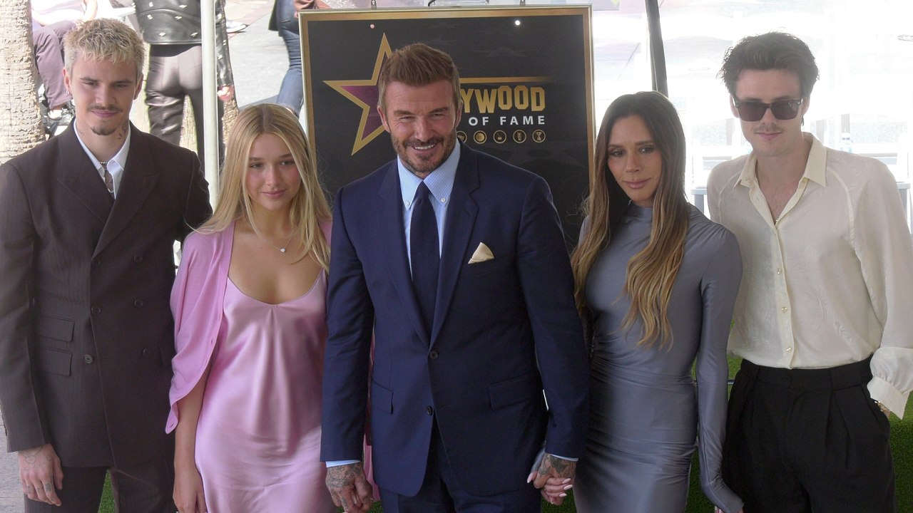 David Beckham poses with his family next to his star on the Hollywood Walk of Fame