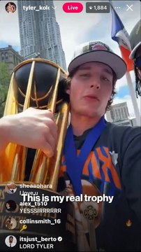 Tyler Kolek celebrates with the NBA Cup at Knicks parade