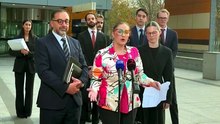 Felicity Button, a Robo Debt victim, talks to the media in Melbourne