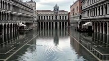 Cinematic drone shot of Venice in extreme acqua alta flood, St Mark's Square fully submerged, gondolas floating past second-floor windows, dramatic overcast sky, 4K, 10 seconds