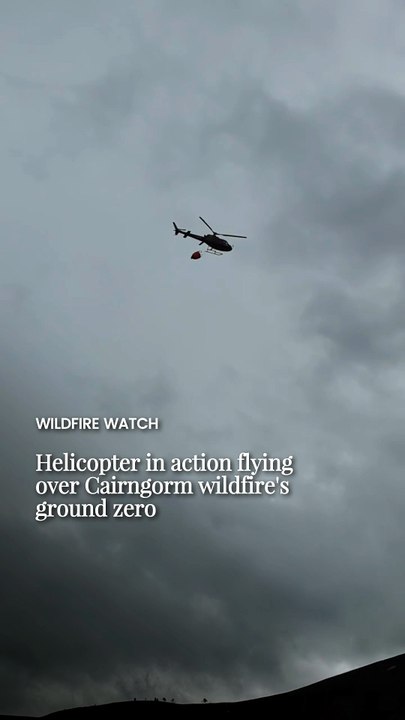 Helicopter in action flying over Cairngorm wildfire