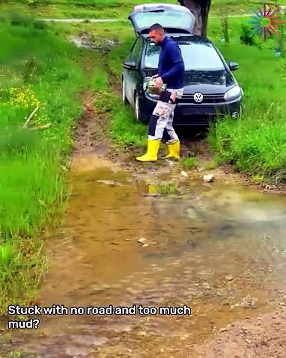 Car passes the road covered in mud