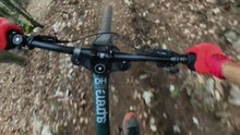 Unexpected fall on a sharp trail turn interrupts a pro biker’s thrilling ride