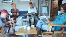 Unplanned entertainment at a café as man observes a couple playing footsie