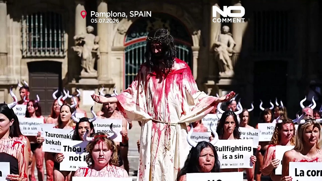 Activists covered in red paint protest bullfighting in Pamplona