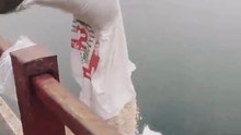 Feeding Fish from the Bridge