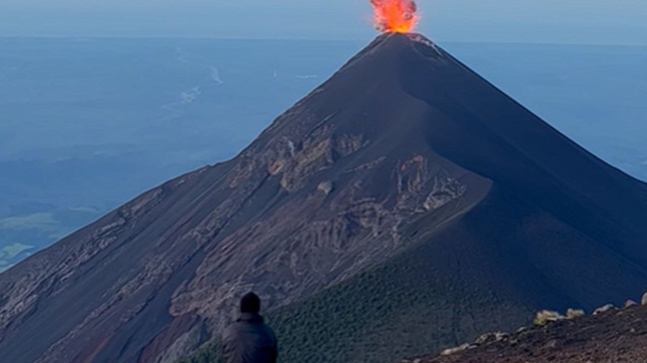 Solo traveler revels in the breathtaking view of the eruption of Acatenango Volcano