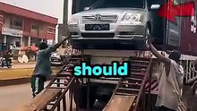 A brand new $100,000 car was being unloaded using sketchy metal ramps and wooden planks.
