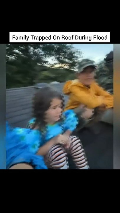 Family Trapped On Roof During Flood