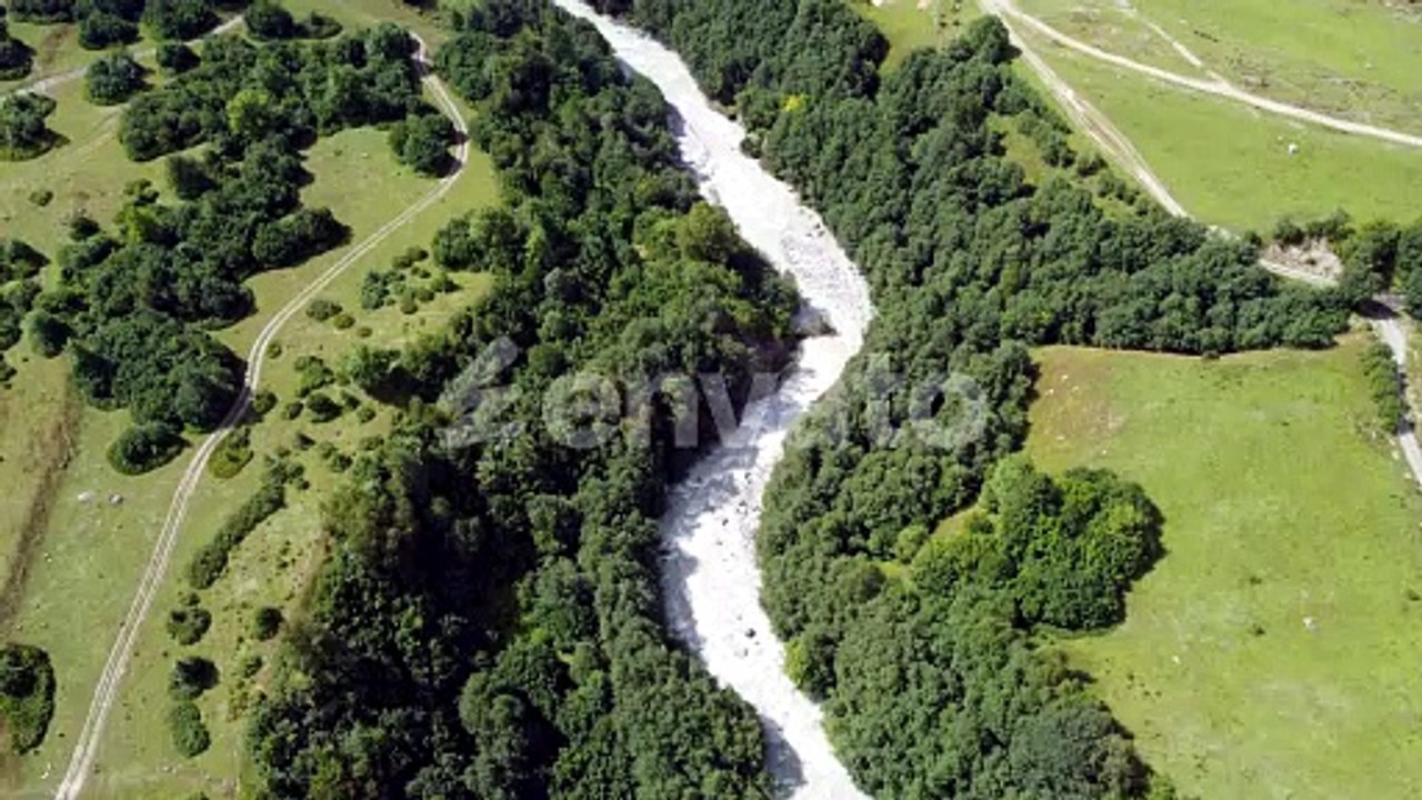 Breathtaking mountain valley with winding river and lush greenery