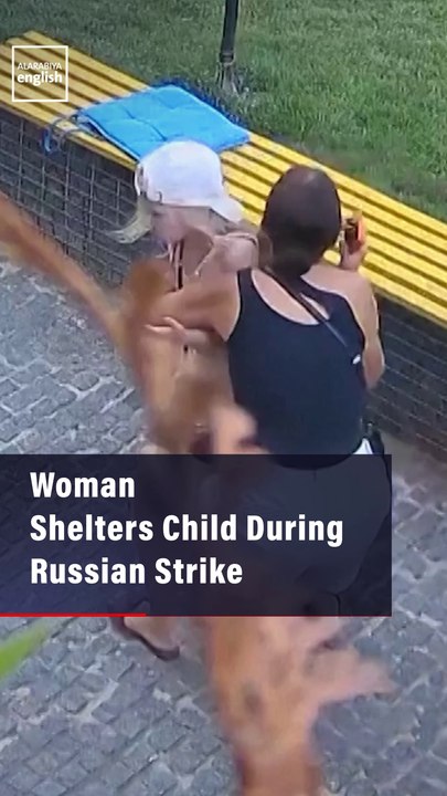 Woman Shelters Child During Russian Strike