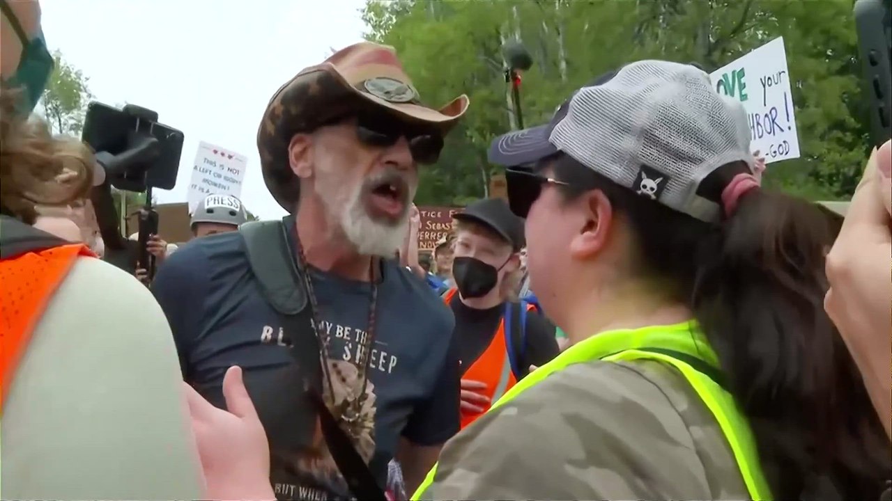Armed ICE SUPPORTER confronts PROTESTER outside ICE OFFICE in MAINE in WILD scene