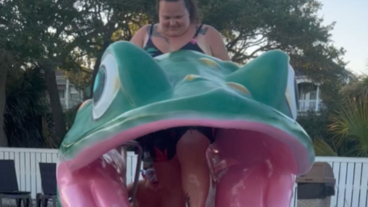 Woman Slides Down A Frog Slide And Goes Underwater