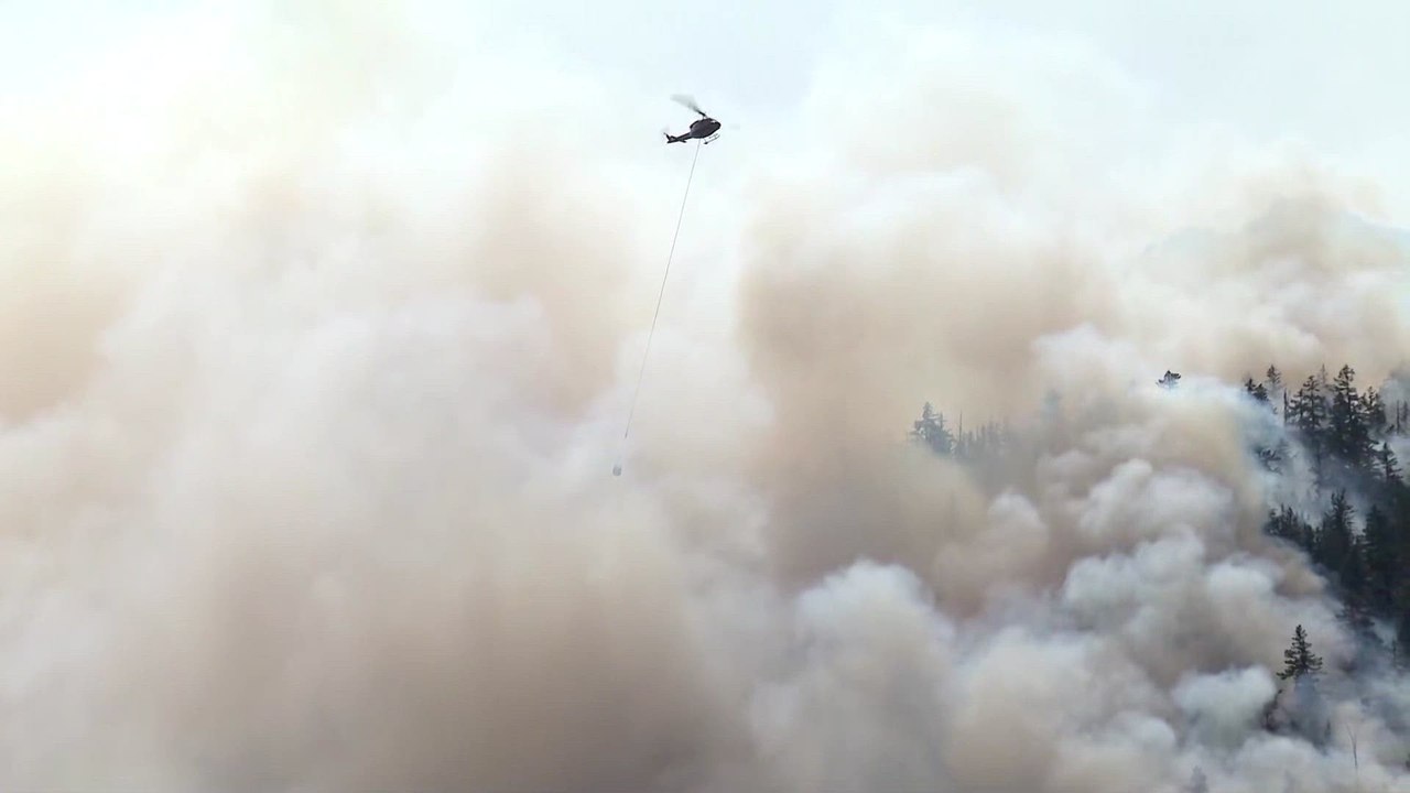 Firefighter helicopter drops water on Canada wildfire