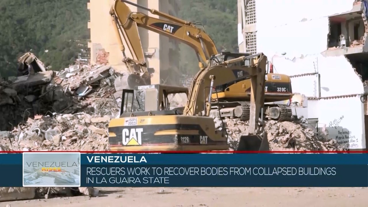 Rescuers work to recover bodies from collapsed buildings in La Guaira state