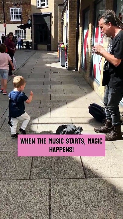 The little boy bursts with excitement when live music starts playing