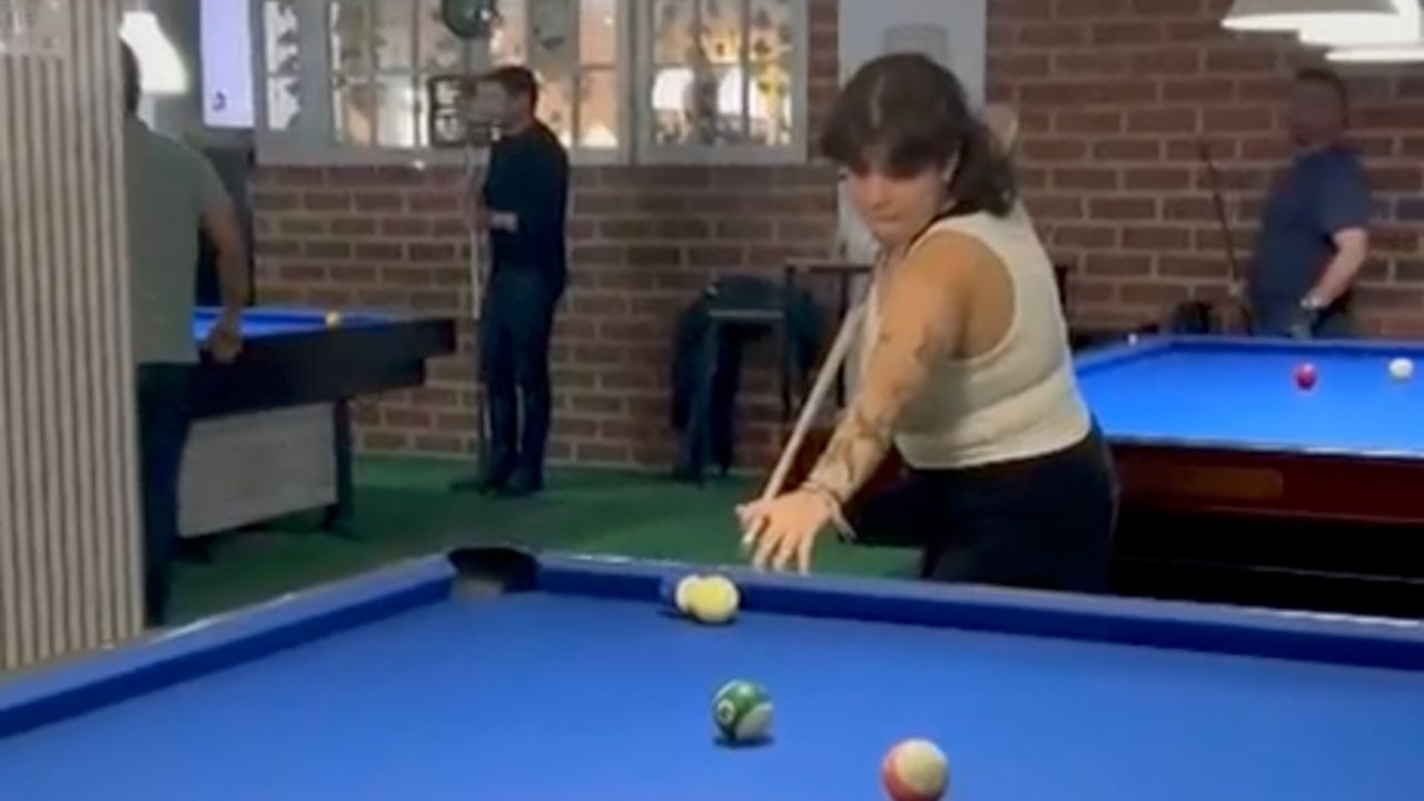 Woman Accidentally Hits The Billiards Light While Lining Up A Shot