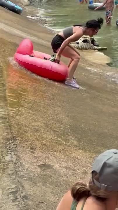 Woman Falls Into River After Struggling to Get Float Tube Into Water