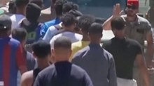 Desperate migrants pack water distribution point