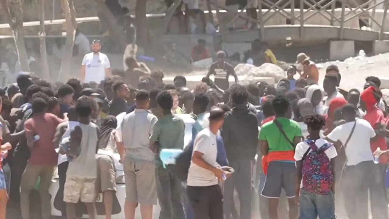 Migrants fight over aid on Ceuta beach as hundreds set up camp