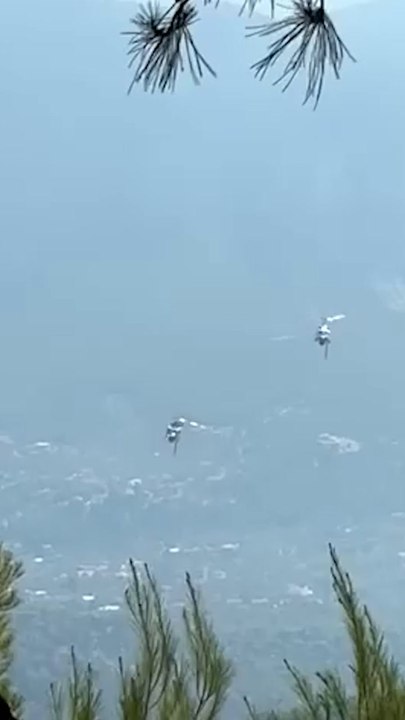 Terrifying moment firefighting helicopters collide mid-air