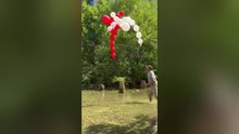 Grandfather and Grandson Create Dancing Balloon Figures in Summer Stre