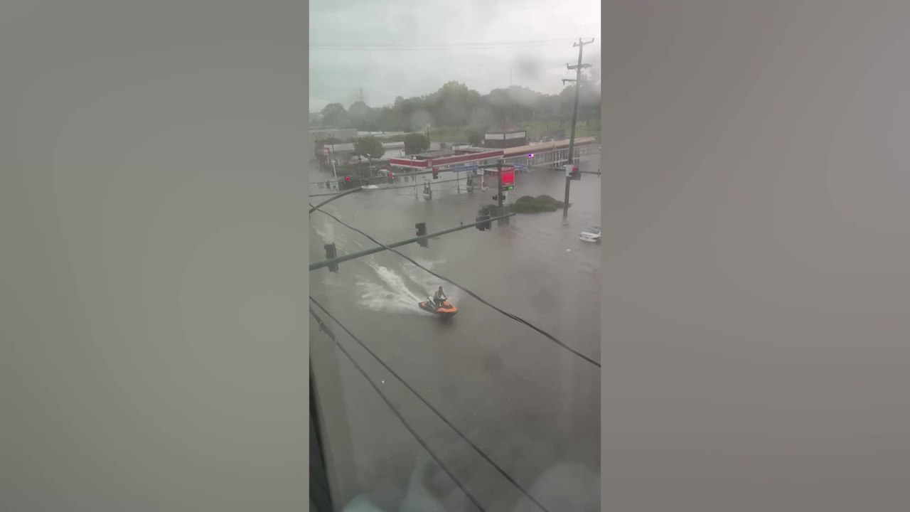 Man Jet Skis Through Flooded Norfolk Streets Af...