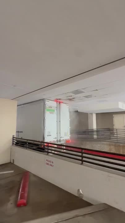 Truck Hits Ceiling Sprinkler and Gets Stuck in Underground Parking