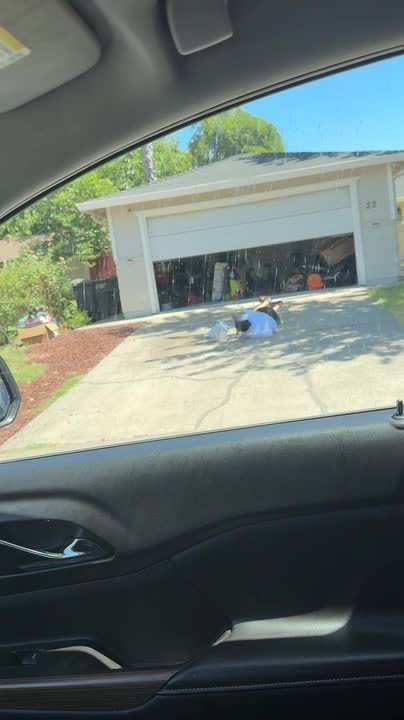 Woman Falls While Running Out of Closing Garage