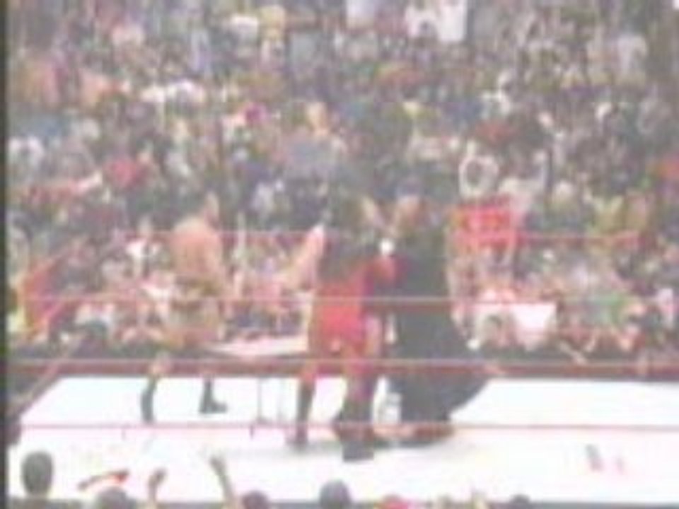 Undertaker and Kane  chokeslam HHH through a table